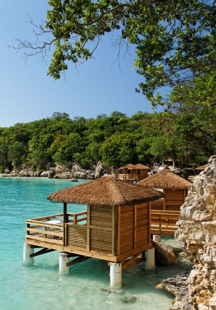 Overwater cabanas on turquoise bay in Negril Jamaica