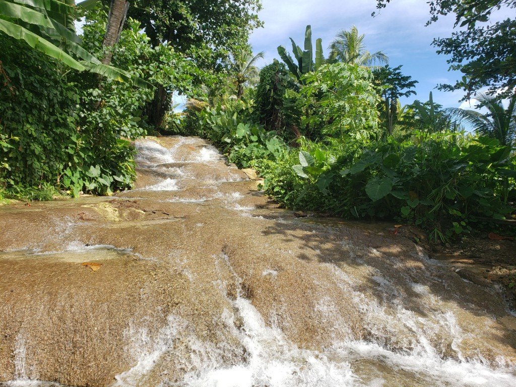 Tropical waterfall surrounded by lush greenery in Ocho Rios