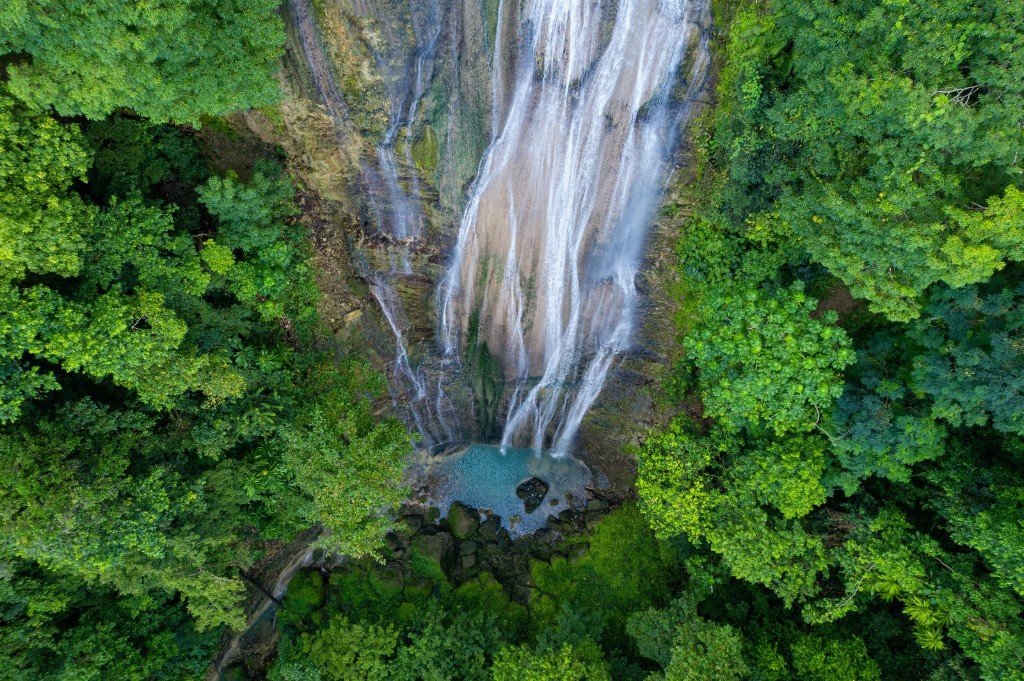 Waterfall and turquoise pool in Portland Jamaica rainforest